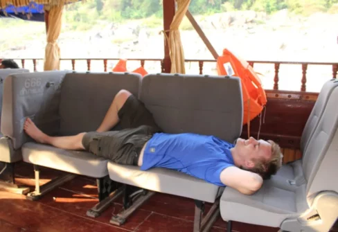 Matt relaxing on a boat in Laos